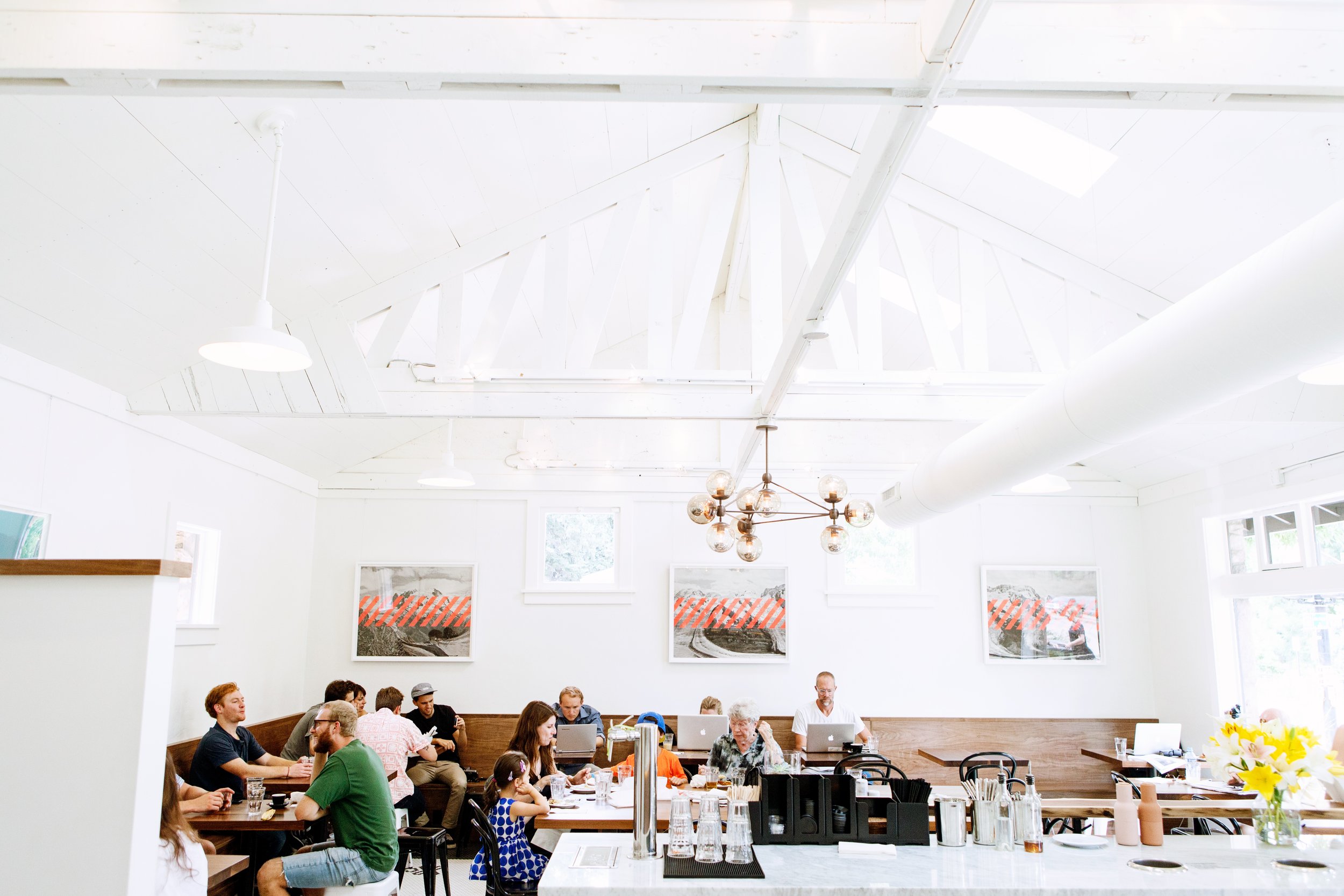 Guests working and gathering inside Alpine Modern Cafe's University Hill location in Boulder, Colorado